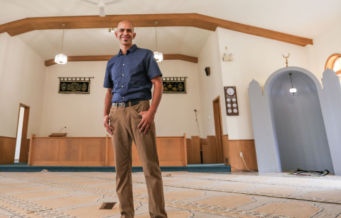 Smiling Dr. Tim El Tahan standing in mosque